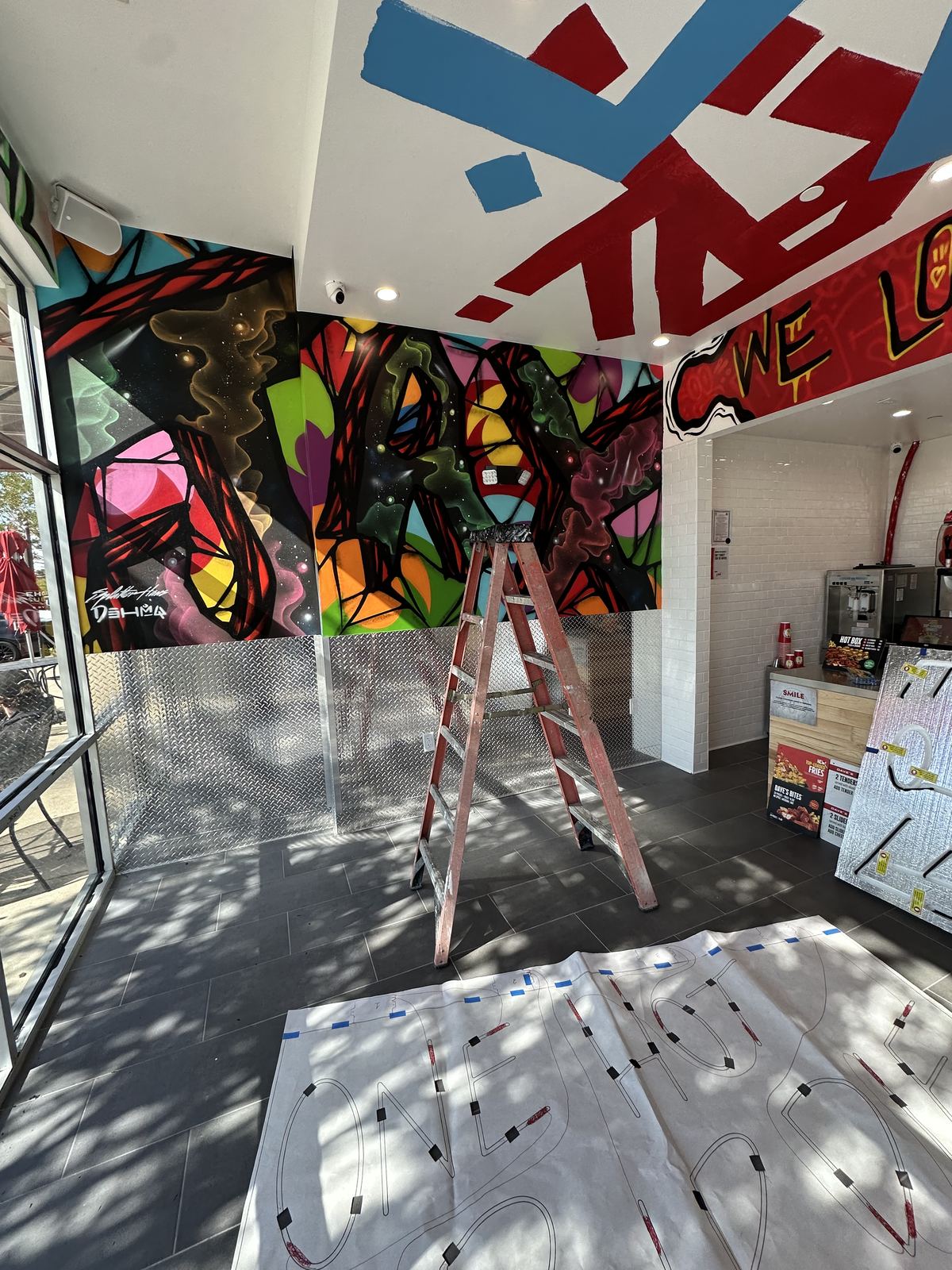 Ceiling mural being hand-painted mid-progress
