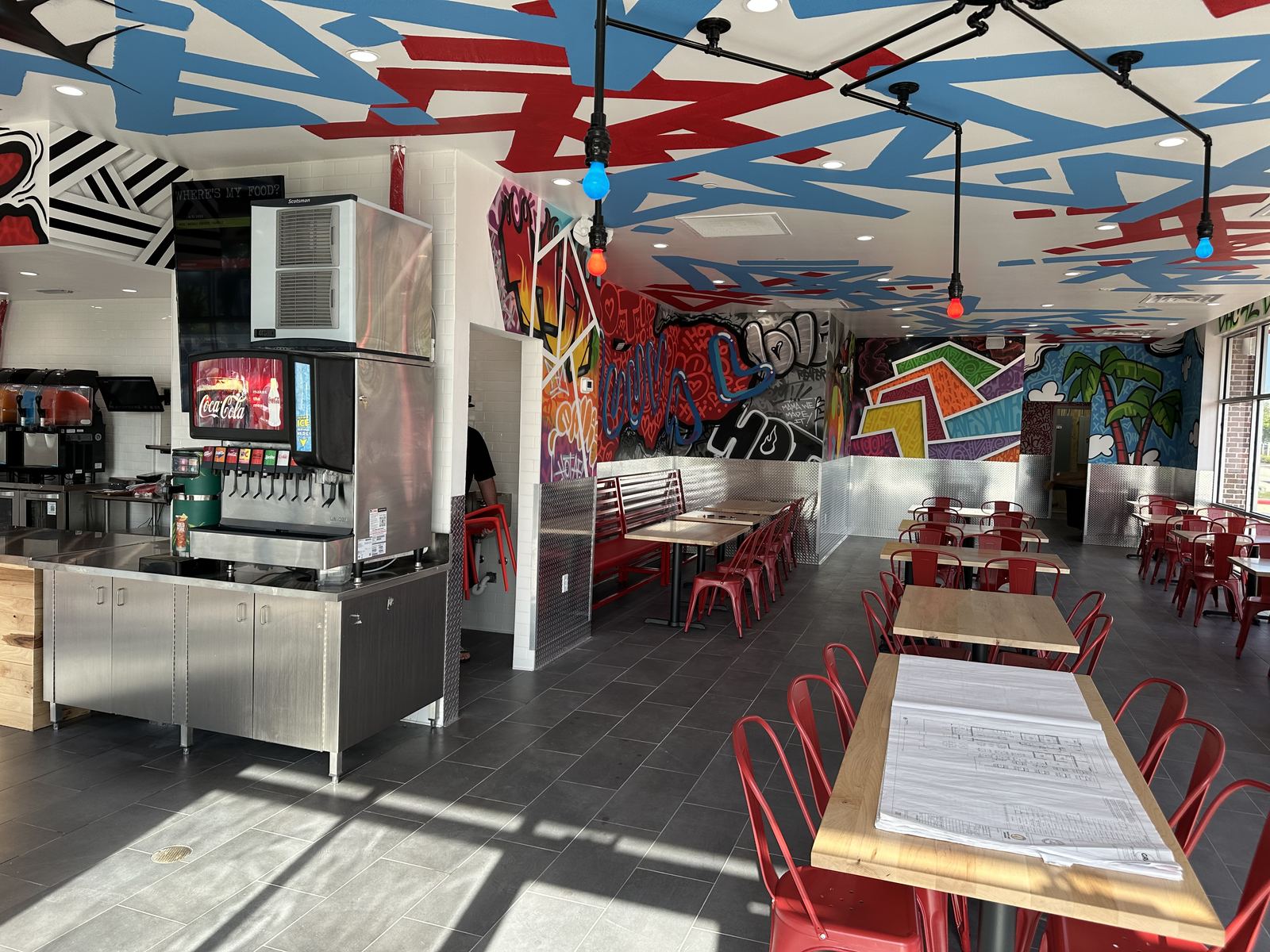 Dining room seating area with graffiti-style mural artwork