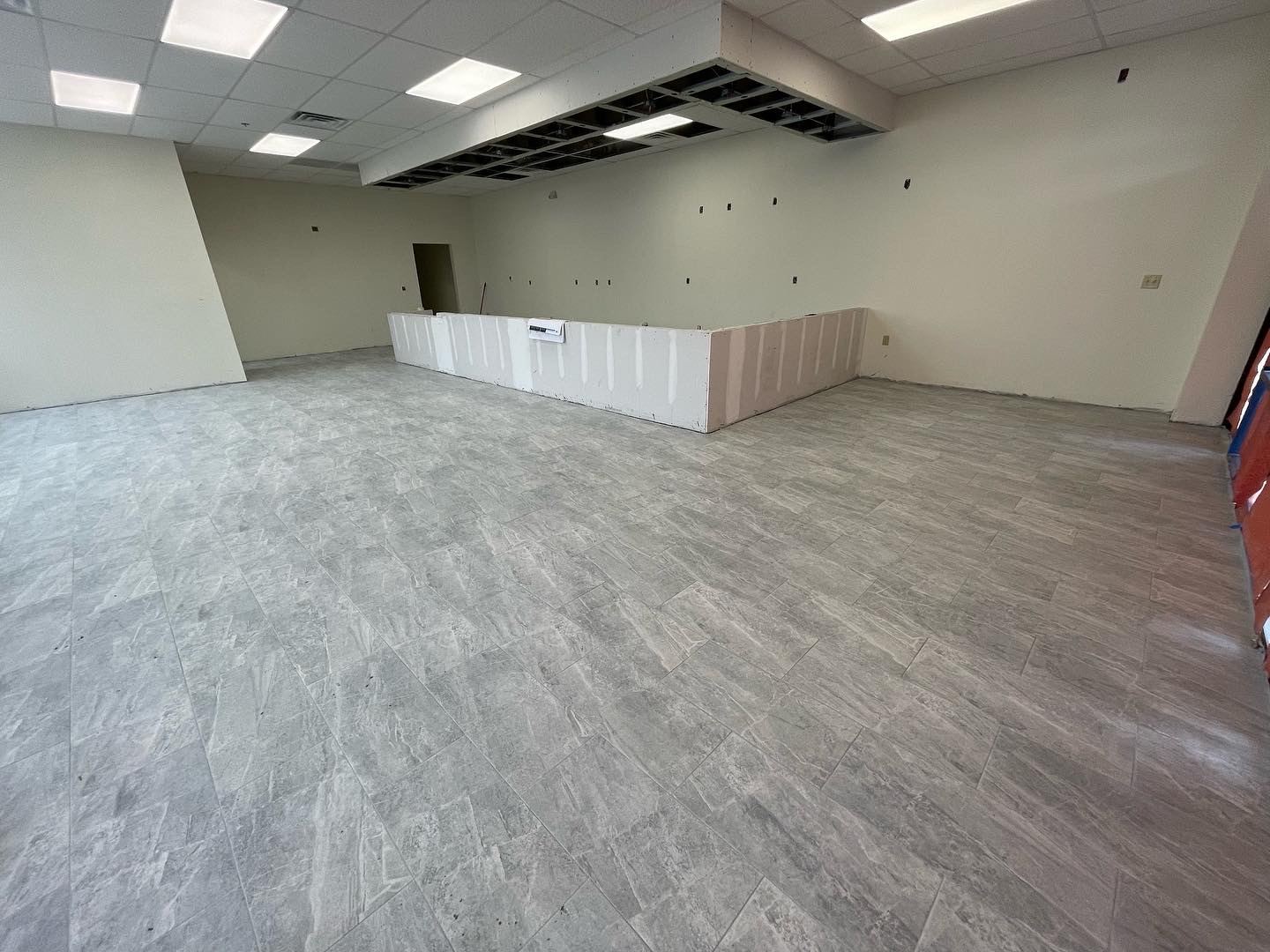 Finished large-format tile floor in Jacksonville commercial retail buildout