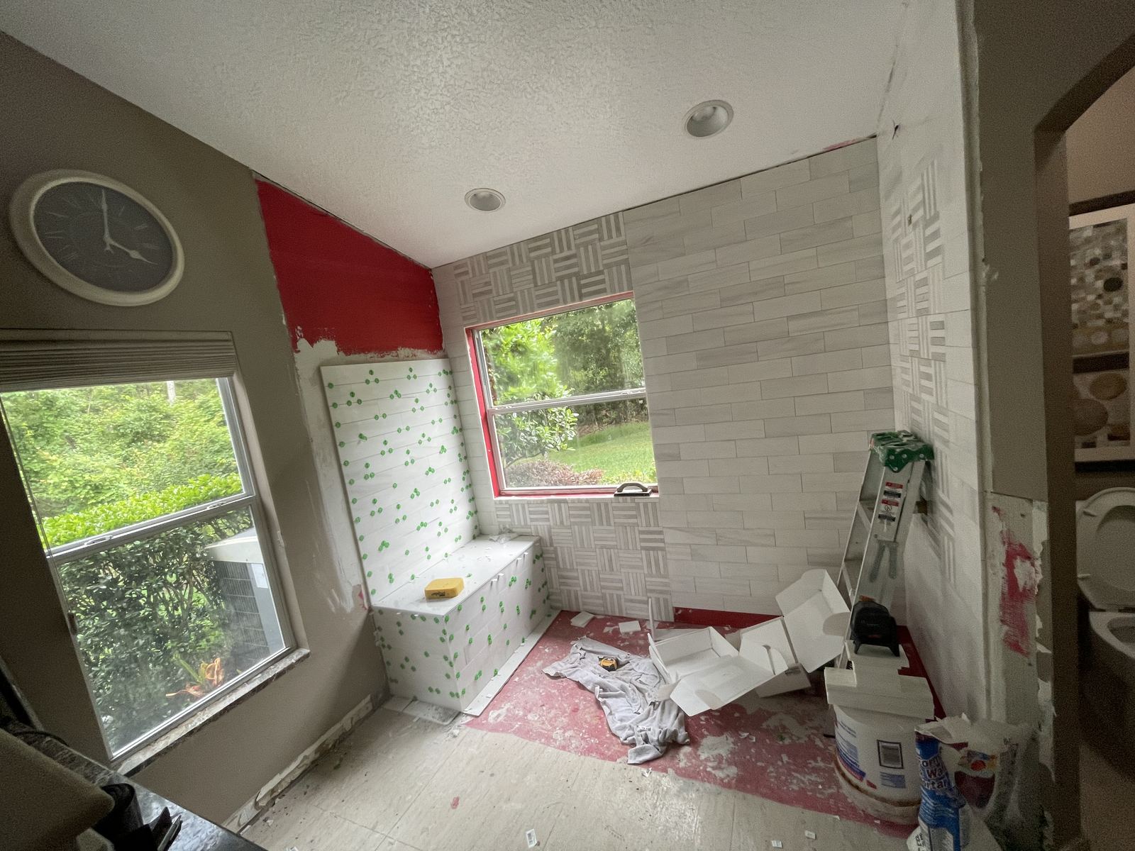 Basket-weave mosaic and subway tile installation in progress