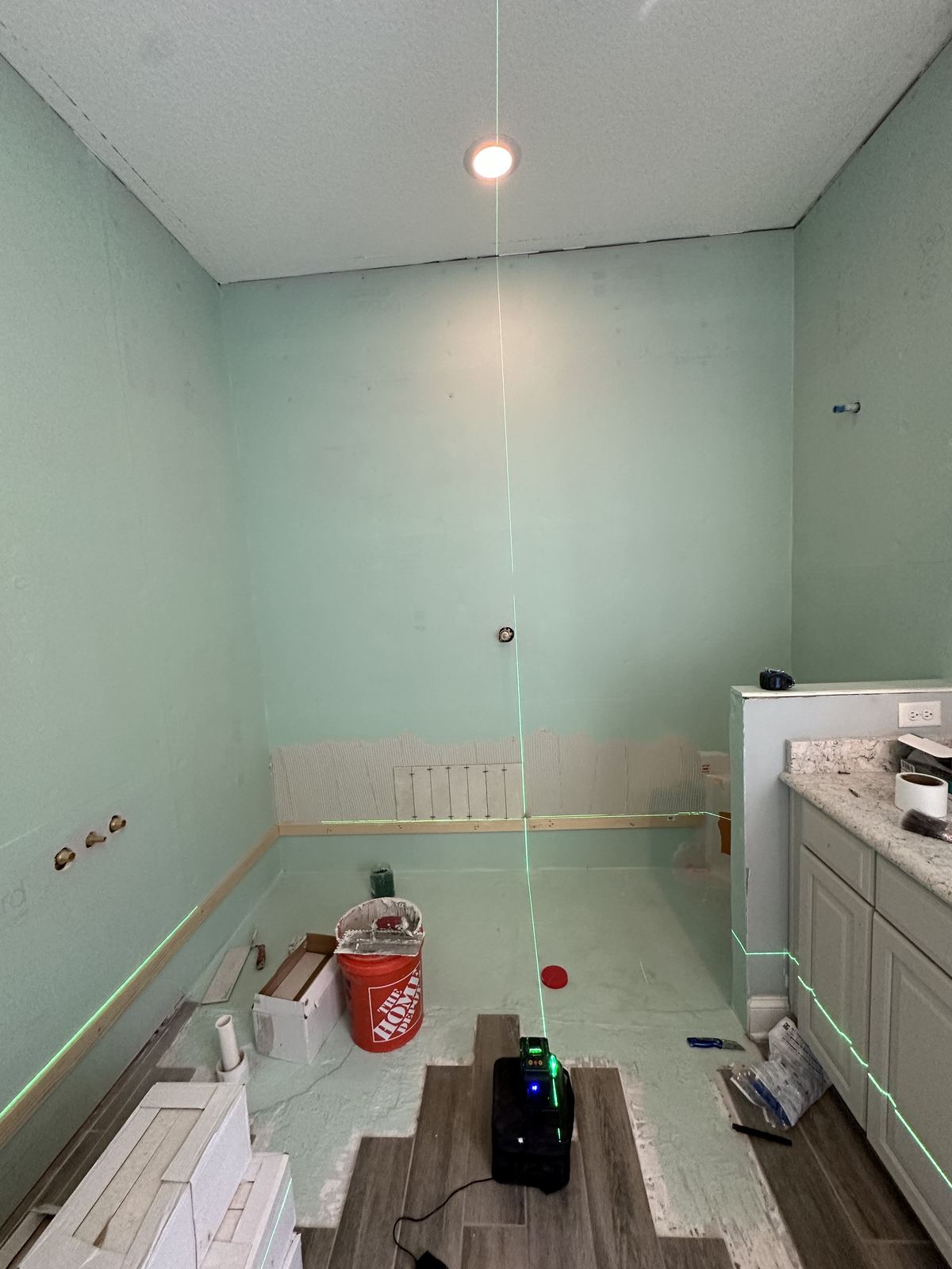 Bathroom stripped to green board before tile installation