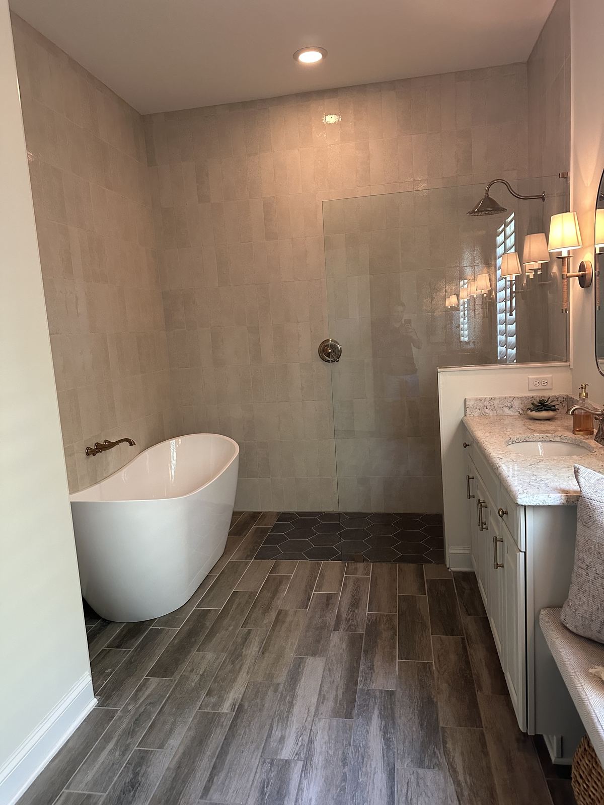 Finished primary bath with freestanding tub and walk-in glass shower