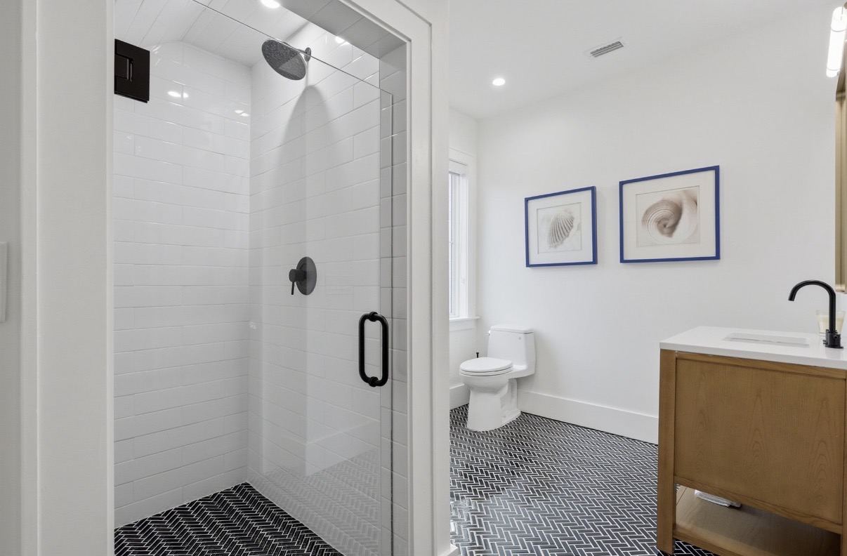 Guest bath with fluted wood double vanity and large art piece