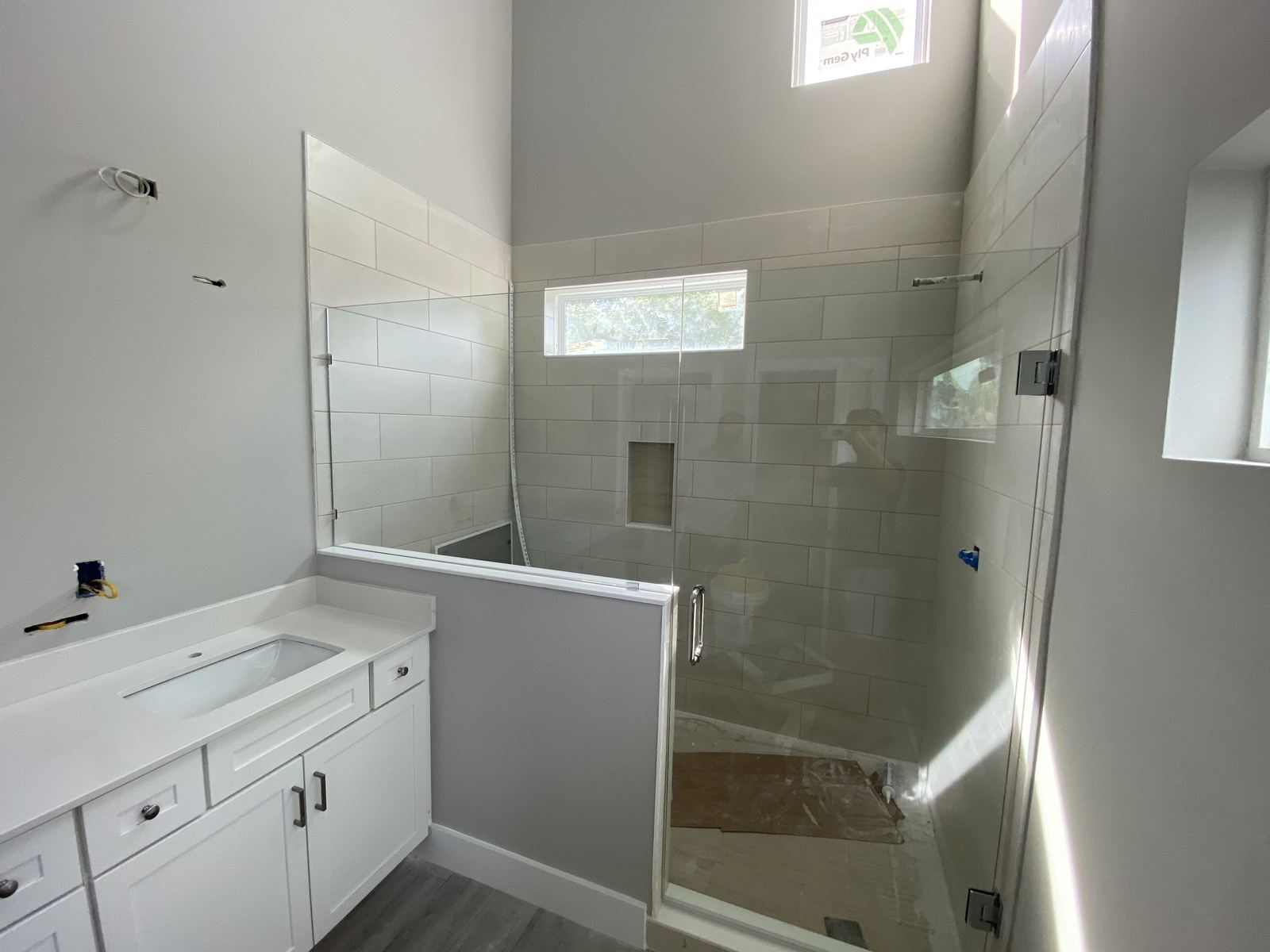 Finished bathroom with glass shower and white vanity