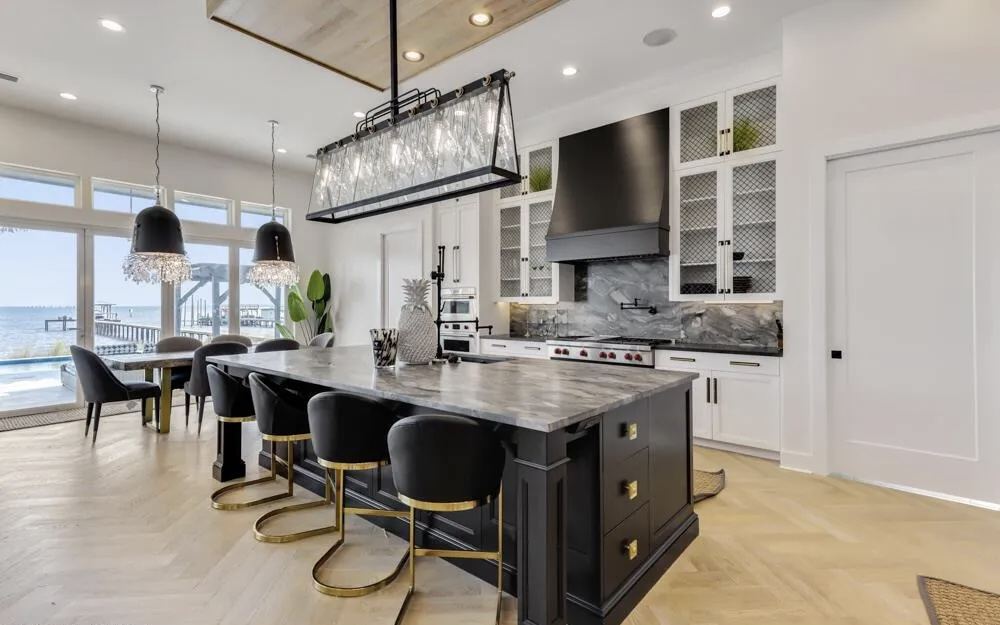 Waterfront kitchen island with marble countertop and water view